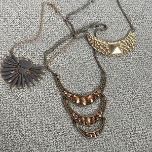 3 necklaces, gold, rose gold, and purple gemstones
